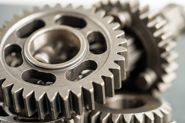 istock Gear and cogs wheels, clock mechanism, brass metal engine industrial. 1487321465