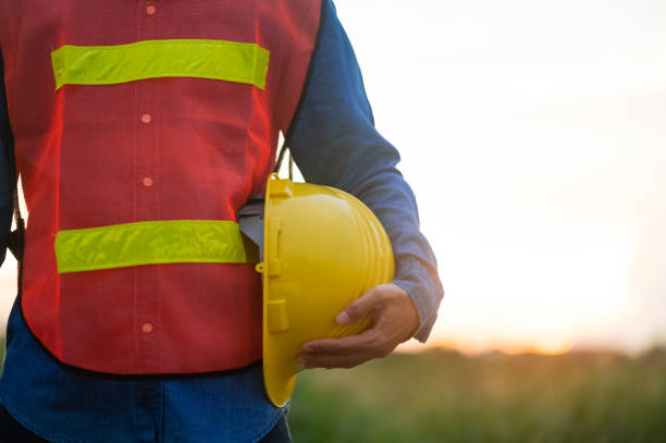 istock Engineer holding hard hat construction worker professional safety work industry building person manager service 1487323672