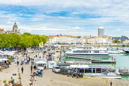 Quays of the Old Port of La Rochelle seen from the Rue sur les Murs walkway at the entrance of the Chain Tower in France