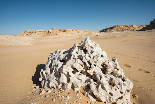 Landscape scenic view of desolate barren western desert in Egypt with geological eroded rock formations