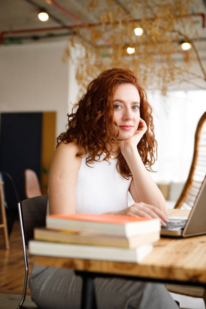 istock redhead woman working in a modern office 1487325894
