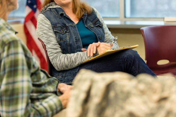 istock Unrecognizeable people sit in the community center for group therapy 1487326337
