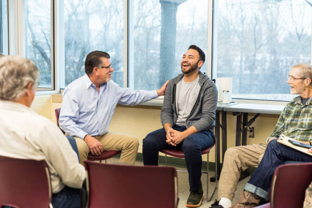 istock Multigenerational group of people sit in a circle for group therapy 1487326366