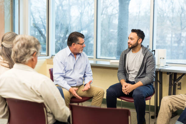istock Counselor helps explain to the young man that his emotions are valid 1487326388