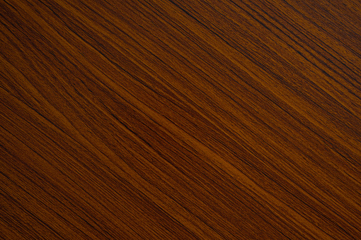 Reddish brown wood grain background.