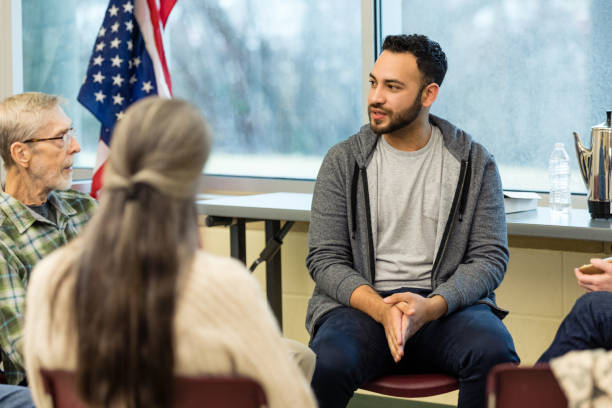 istock During support group, senior man and young man talk one-on-one 1487328373