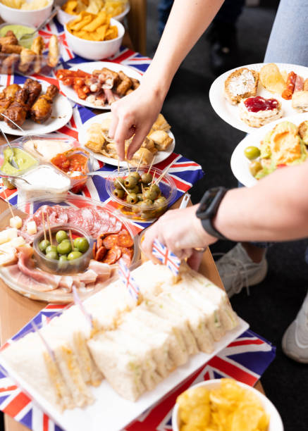 indulging in party food - real people blue white friendship imagens e fotografias de stock