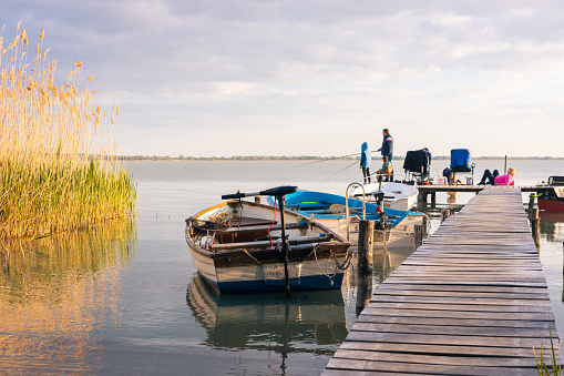 Family vacation at Lake Balaton, Fishing together, Boats, Setting sun, Hungary, Lake Balaton, May 1, 2023