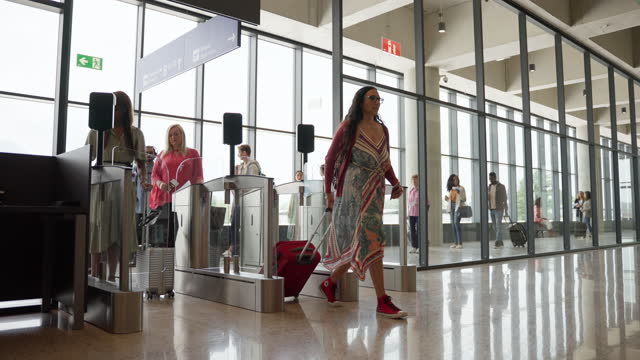 Passengers Scanning Boarding Passes at Airport Terminal