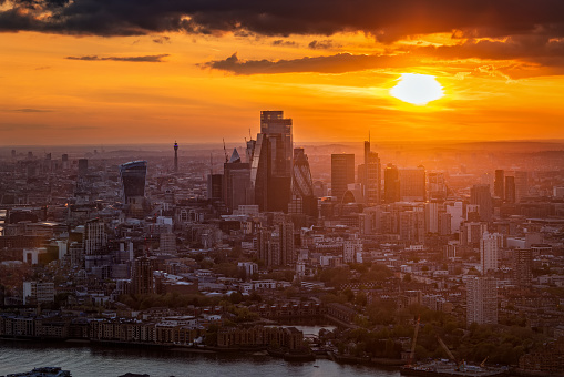 Elevated, panoramic view of the skyline at the City of London, England, during a golden sunset