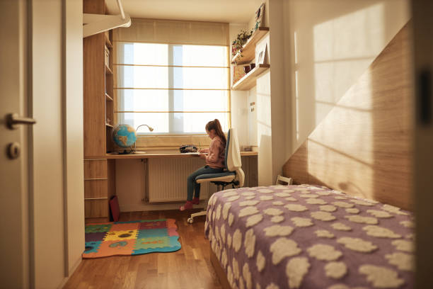 istock Schoolgirl studying at home 1487340401