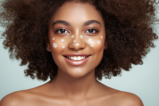 Studio shot of young beautiful woman. Professional make-up and hairstyle. 