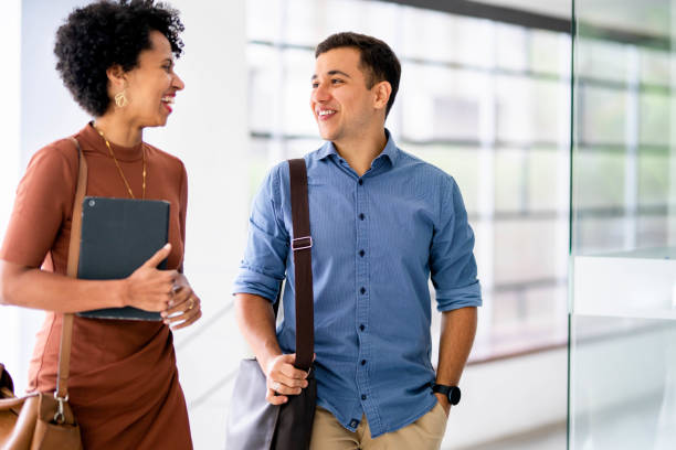istock Diverse young businesspeople talking and laughing in their office 1487345067