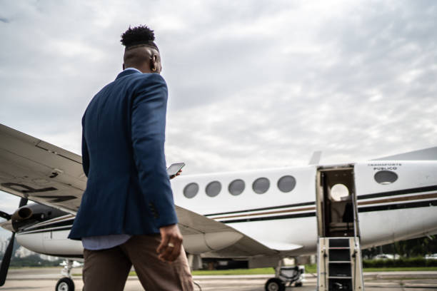 istock Mid adult man using mobile phone while walk in the airport hangar 1487345367