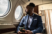 Mid adult businessman contemplating on a private jet