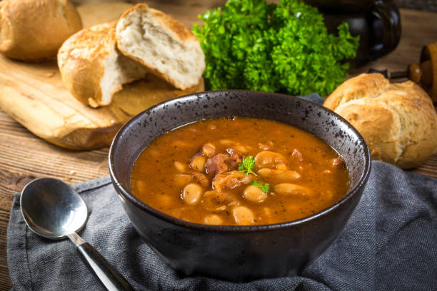 istock Beans with tomato sauce, bacon and sausage. 1487346443