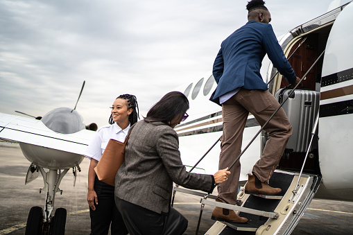 Passengers going up the private jet ladder