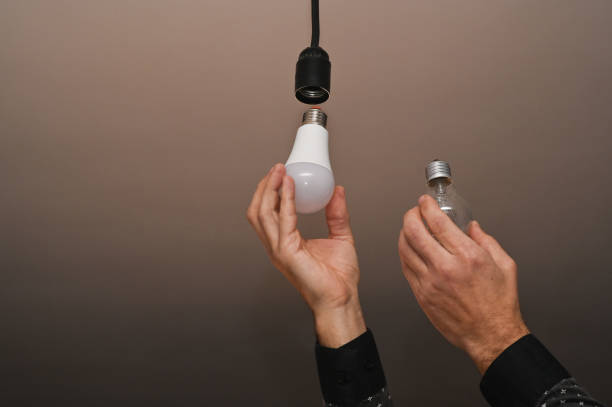 istock two lamps in the hands, LED and incandescent. 1487349195