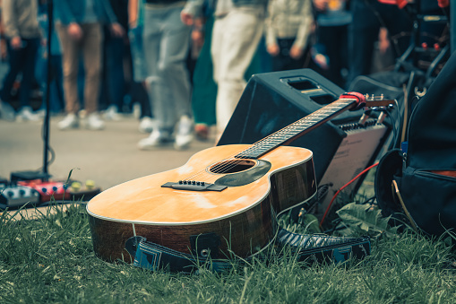 Acoustic guitar on the grass.
