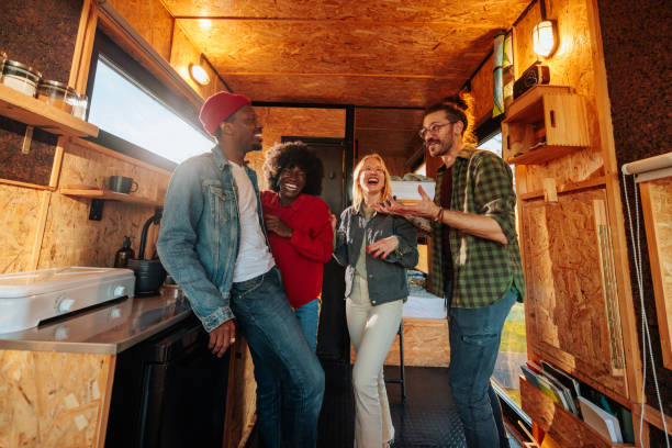 istock Smiling friends in small vacation cabin. 1487351834