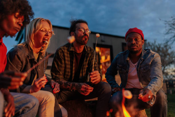 istock Friends eating marshmallow at camp. 1487351999