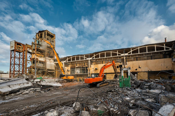 istock Hydraulic excavators at demolition site of industrial complex 1487353041
