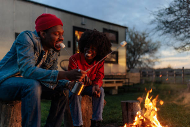 istock Young couple at campfire outdoors. 1487353283