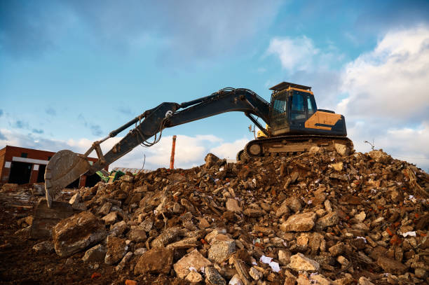 istock Building excavator on concrete pieces at demolition site 1487353349