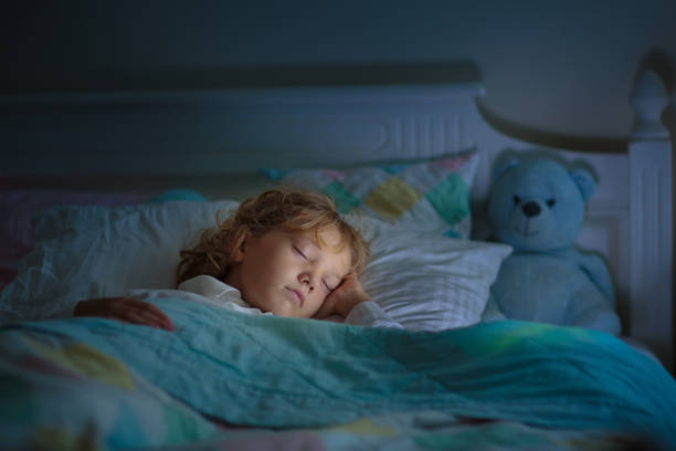 istock Child sleeping in dark bedroom. Little boy napping 1487353730