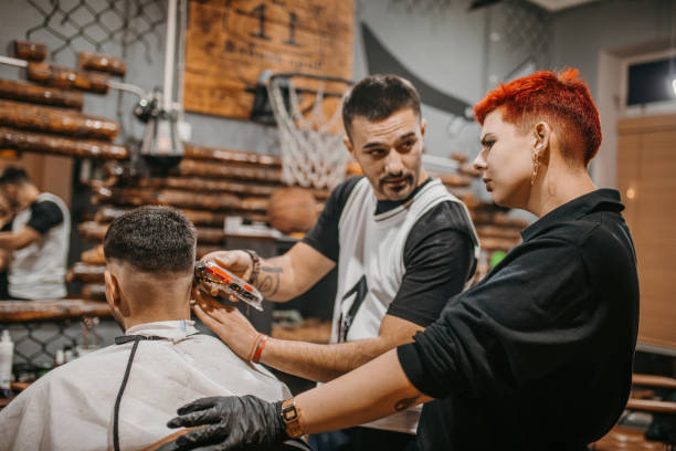 istock A young female barber in training in a barbershop 1487354335