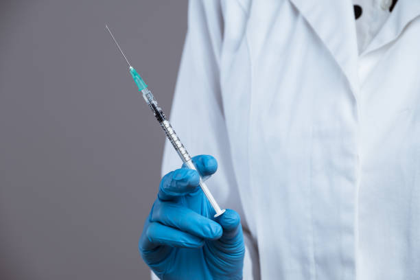 istock Doctor holding syringe. 1487356179