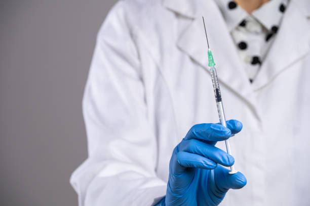 istock Doctor holding syringe. 1487356200