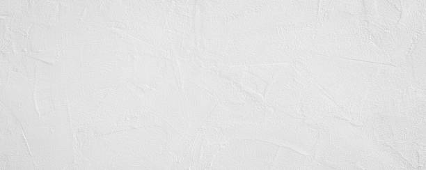 istock White rough grainy stone or plastered wall texture background 1487356402