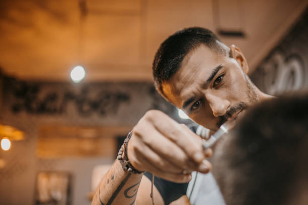 istock Young male barber working at barber shop 1487356569