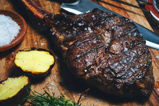 istock Grilled Tomahawk Steak with Baked Potato 1487357927