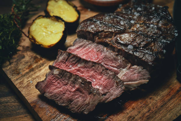 istock Grilled Tomahawk Steak with Baked Potato 1487358023