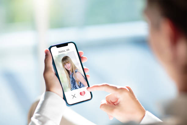 istock Man looking at dating app profile on mobile phone 1487358445