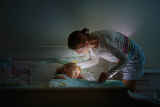 istock Child sleeping in dark bedroom. Little boy napping 1487359202