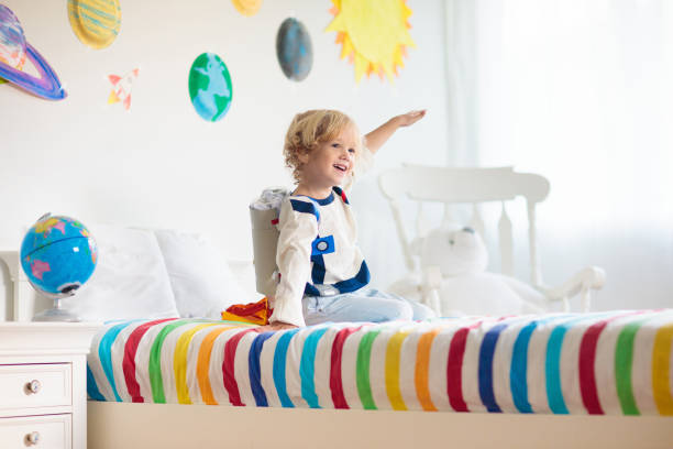istock Kids play astronaut. Space and planet child game. 1487359236