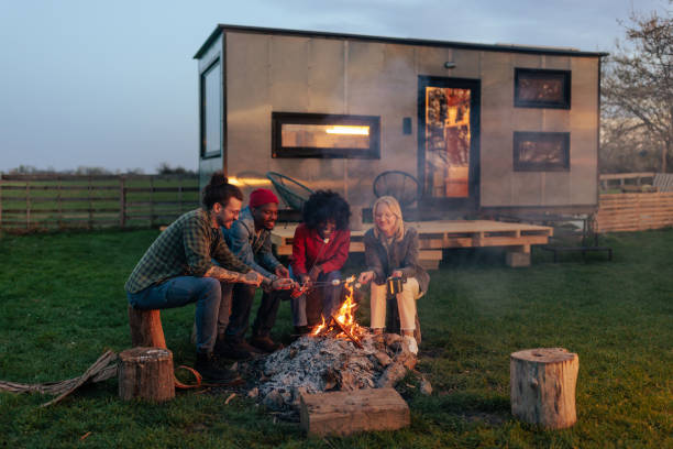 istock Cheerful couples at campfire on vacation. 1487359707