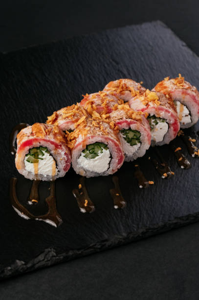 istock fresh japans sushi on a black background 1487359846