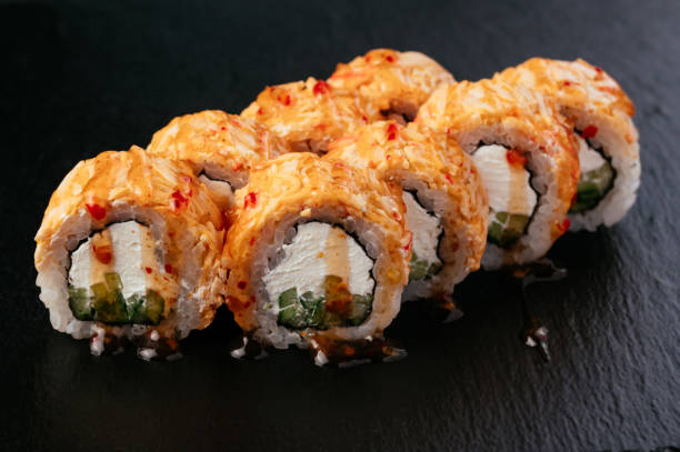 istock fresh japans sushi on a black background 1487359903