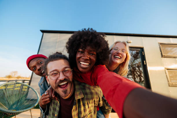istock Happy friends taking selfie outdoors point of view. 1487359912
