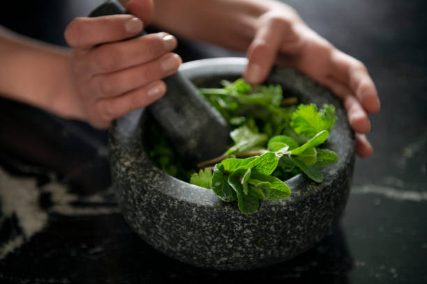 istock Grinding herbs with a mortar and pestle 1487360674