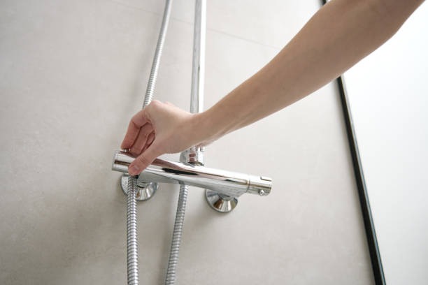 istock Woman use shower in bathroom 1487360675