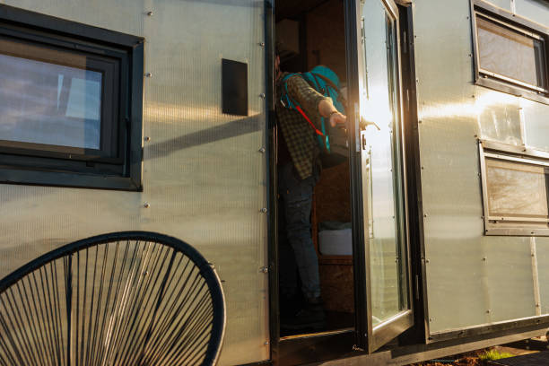 istock Man closing caravan cabin door. 1487360946