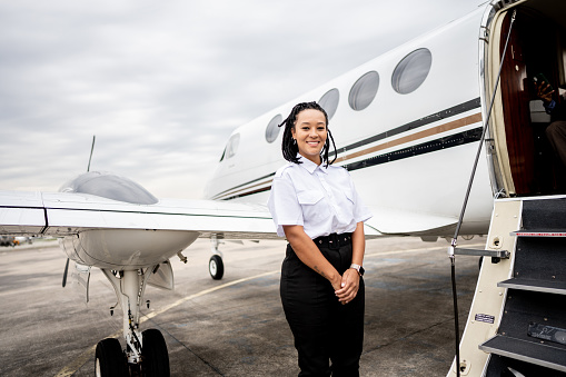 Portrait of a air stewardess in the airport hangar