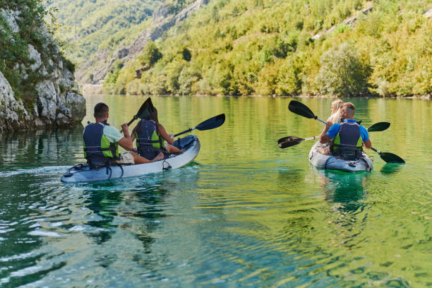 istock A group of friends enjoying having fun and kayaking while exploring the calm river, surrounding forest and large natural river canyons 1487362797
