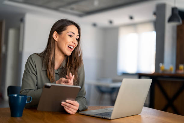 istock Young female freelancer or remote teacher using laptop, remote studying, virtual training, participating in online education webinar 1487362899