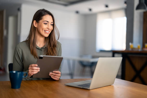 istock Confident businesswoman executive coach in casual clothes using laptop computer 1487362921